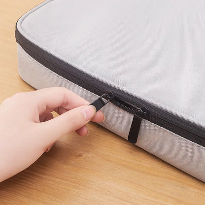 Hand zipping the Large-Capacity Waterproof Document Organizer Bag – Multi-Pocket File Holder for Travel, Office, School.